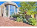 Contemporary home with large windows and desert landscaping at 10040 E Happy Valley Rd # 1047, Scottsdale, AZ 85255