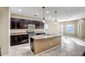 Kitchen with dark brown cabinets and granite countertops at 10789 W Saddlehorn Rd, Peoria, AZ 85383