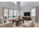 Spacious living room featuring high ceilings and large windows at 14428 W Faye Way, Surprise, AZ 85387