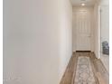 Light and bright entryway with wood-look flooring and access to other rooms at 1702 W Flintlock Dr, San Tan Valley, AZ 85144
