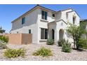 Two-story house with tan exterior, two-car garage, and desert landscaping at 1702 W Flintlock Dr, San Tan Valley, AZ 85144