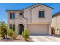 Two-story house with light-beige exterior, two-car garage, and landscaping at 1702 W Flintlock Dr, San Tan Valley, AZ 85144