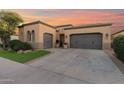 Attractive curb appeal featuring a gray garage and well-manicured lawn at 1713 E Amaranth Trl, Queen Creek, AZ 85140