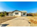 Ranch style home with a spacious yard and driveway at 214 W June Cir, Mesa, AZ 85201