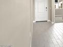 Modern entryway with neutral tile floor and white door at 23963 W Cocopah St, Buckeye, AZ 85326