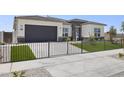 Modern house with a two-car garage and artificial turf at 25224 N 159Th Dr, Surprise, AZ 85387