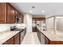 Spacious kitchen featuring granite countertops and stainless steel appliances at 3583 N Brooklyn Dr, Buckeye, AZ 85396