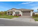 One-story home with a covered porch, two-car garage, and landscaping at 3620 E Austin Dr, Gilbert, AZ 85296