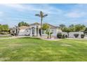 Attractive single story home displaying a lush lawn and mature trees set against a beautiful blue sky at 4135 E Hale Cir, Mesa, AZ 85205