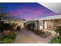 Charming courtyard entry with stone and gravel landscaping, leading to the home's entrance at 4222 E Mcdonald Dr, Paradise Valley, AZ 85253