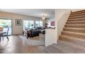 Open living room with tiled floors and access to backyard at 44192 W Canyon Creek Dr, Maricopa, AZ 85139