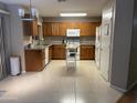 Spacious kitchen with wood cabinets, granite countertops, and tile floors at 5222 W Buffalo St, Chandler, AZ 85226