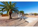 Tan single-wide manufactured home with carport, white railing, and palm tree at 952 S Esperanza Ave, Mesa, AZ 85208