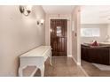 Bright entryway with a white console table and a wooden door at 1018 W Ivanhoe St, Chandler, AZ 85224