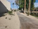 A paved pathway winds through a lush, tree-lined community at 11042 N 28Th Dr # 136, Phoenix, AZ 85029