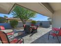 Covered patio with red chairs and a table, perfect for outdoor dining at 12424 W Bluestem Dr, Sun City West, AZ 85375