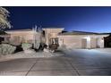 Elegant home exterior at night at 12887 N 135 St, Scottsdale, AZ 85259