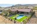 Aerial view of house showcasing a luxurious pool and beautifully landscaped backyard at 13222 E Ranch Gate Rd, Scottsdale, AZ 85255