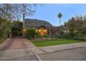 Brick home with a covered carport and spacious yard at 1325 W Lynwood St, Phoenix, AZ 85007