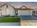 Farmhouse exterior at dusk with landscaping and a two-car garage at 17155 W Gracemont St, Surprise, AZ 85388