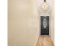 Light-colored entryway with wood-look flooring and a black door at 22183 N 178Th Ave, Surprise, AZ 85387