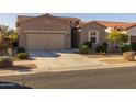 Single-story home with a two-car garage and desert landscaping at 2653 E Marcos Dr, Casa Grande, AZ 85194