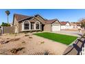 Landscaped front yard with artificial turf and drought-tolerant plants at 2716 N 88Th Ln, Phoenix, AZ 85037