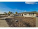 Charming ranch style home with a spacious front yard and walkway at 2870 W Manzanita St, Apache Junction, AZ 85120