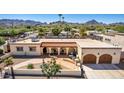 An aerial view showcasing the home's exterior, landscaping, and two-car garage at 3357 E Gold Dust Ave, Phoenix, AZ 85028