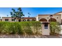 House exterior featuring a lush green hedge and a charming front entrance at 3357 E Gold Dust Ave, Phoenix, AZ 85028