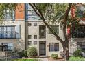 Charming condo with unique window design, complemented by a mature tree providing shade and curb appeal at 3427 E Lance Ln, Phoenix, AZ 85018