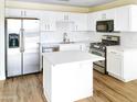 Modern kitchen with stainless steel appliances and white cabinets at 3427 E Lance Ln, Phoenix, AZ 85018