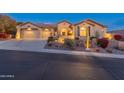 Beautiful home exterior, well-lit at night at 42405 N Anthem Creek Dr, Anthem, AZ 85086