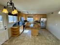 Spacious kitchen featuring granite countertops and stainless steel appliances at 4415 W Palo Verde Ave, Glendale, AZ 85302