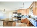 A bright kitchen featuring maple cabinets, granite countertops, stainless appliances and kitchen island at 4415 W Palo Verde Ave, Glendale, AZ 85302