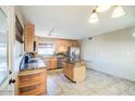 A bright kitchen featuring maple cabinets, granite countertops, stainless appliances and kitchen island at 4415 W Palo Verde Ave, Glendale, AZ 85302