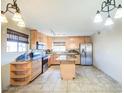 A bright kitchen featuring maple cabinets, granite countertops, stainless appliances and kitchen island at 4415 W Palo Verde Ave, Glendale, AZ 85302