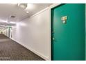 Building hallway with teal door and carpeting at 4750 N Central Ave # A3, Phoenix, AZ 85012