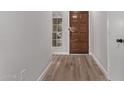 Light and airy entryway with wood flooring and a wooden door at 4963 E Hobart St, Mesa, AZ 85205