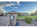 House exterior with a three-car garage and stone mailbox at 5133 W Monte Cristo Ave, Glendale, AZ 85306