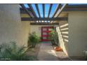 Inviting entryway with red doors and a pathway lined with plants at 6151 E Harvard St, Scottsdale, AZ 85257