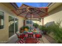 Outdoor patio with seating area, umbrella, and lush landscaping at 6151 E Harvard St, Scottsdale, AZ 85257