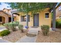 Front view of a two-story townhome with gray door and walkway at 6845 S 7Th Ln, Phoenix, AZ 85041