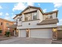 Two-story house with three car garage and stone accents at 687 E Cleveland Ct, San Tan Valley, AZ 85140