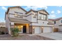 Two story house with three car garage and stone accents at 687 E Cleveland Ct, San Tan Valley, AZ 85140