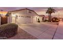 Two-car garage with desert landscaping at 7860 W Taro Ln, Glendale, AZ 85308