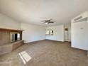 Spacious living room with a fireplace and access to the kitchen at 8738 W Tinajas Dr, Arizona City, AZ 85123