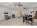 Open living room and dining area with light wood floors and ceiling fans at 1022 E Mariposa St, Phoenix, AZ 85014