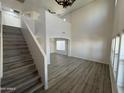 Bright living room with high ceilings, hardwood floors, and loft area at 11658 N 153Rd Ave, Surprise, AZ 85379