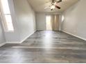 Large bedroom with ceiling fan and wood-look vinyl flooring at 1331 W Baseline Rd # 244, Mesa, AZ 85202